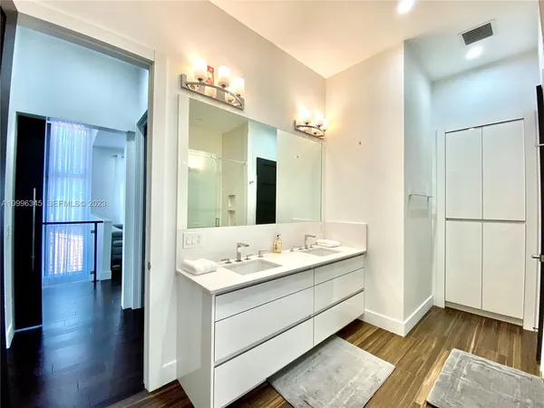 a bathroom with a double vanity sink and a mirror