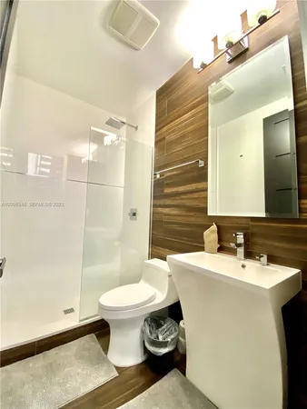 a bathroom with a sink toilet and shower