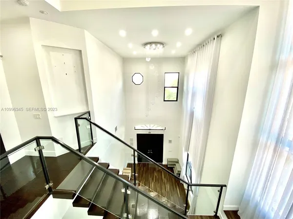 a view of a hallway with seating space