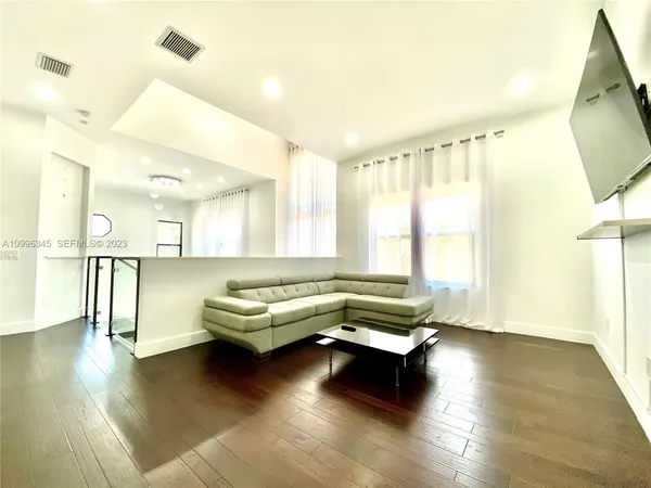 a living room with furniture and a large window