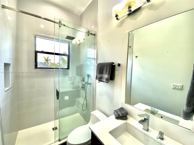 a living room with patio furniture and a large window