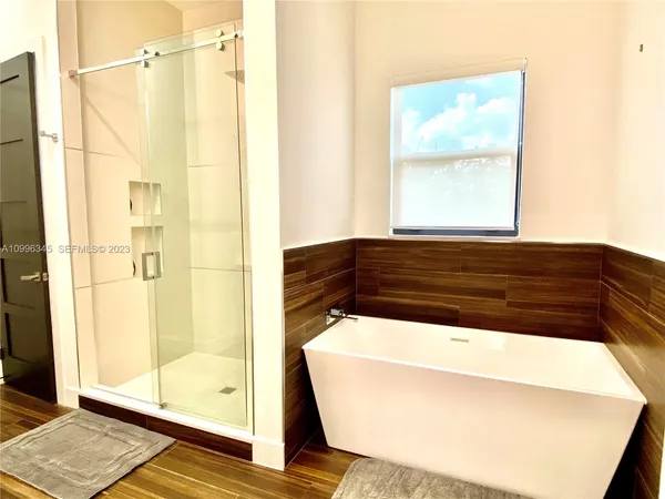 a bathroom with a bathtub and a shower