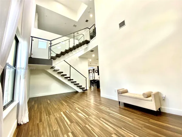 a view of entryway and hall with wooden floor