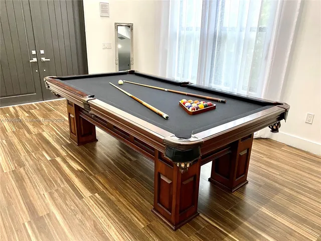 a living room with stainless steel appliances furniture and a large window