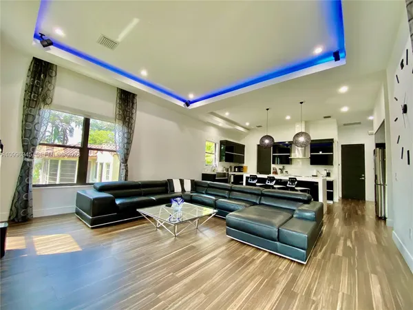 a living room with kitchen island furniture and a wooden floor