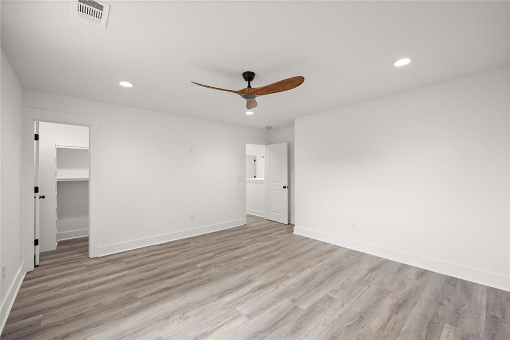 182 Hardman Road Clarkesville, GA 30523 - Photo 29 of 62 an empty room with wooden floor and a ceiling fan