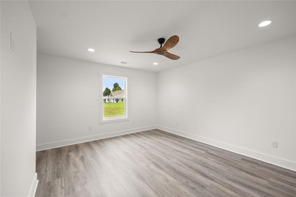182 Hardman Road Clarkesville, GA 30523 - Photo 31 of 62 an empty room with a window and a ceiling fan