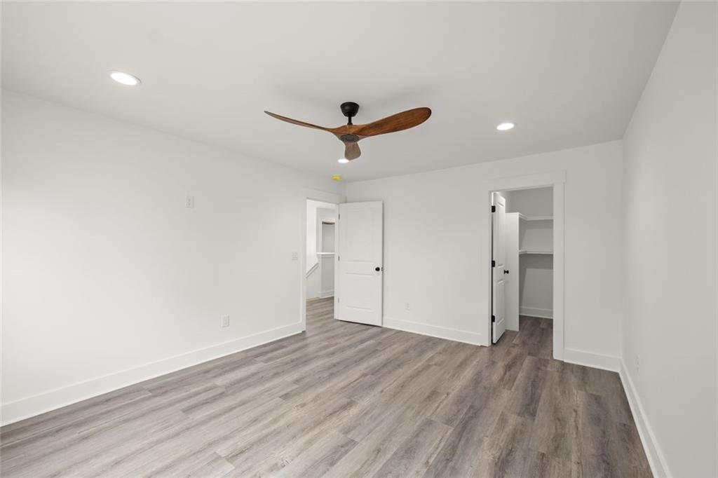 182 Hardman Road Clarkesville, GA 30523 - Photo 36 of 62 an empty room with wooden floor and ceiling fan