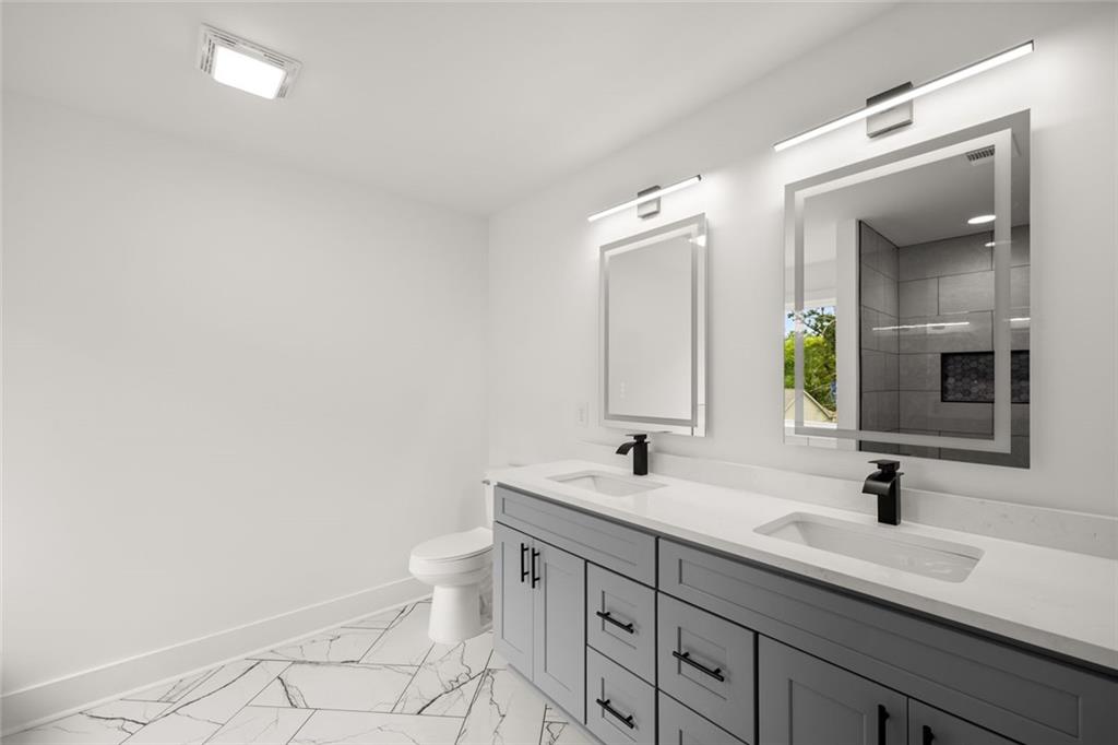 182 Hardman Road Clarkesville, GA 30523 - Photo 43 of 62 a bathroom with a double vanity sink and a mirror