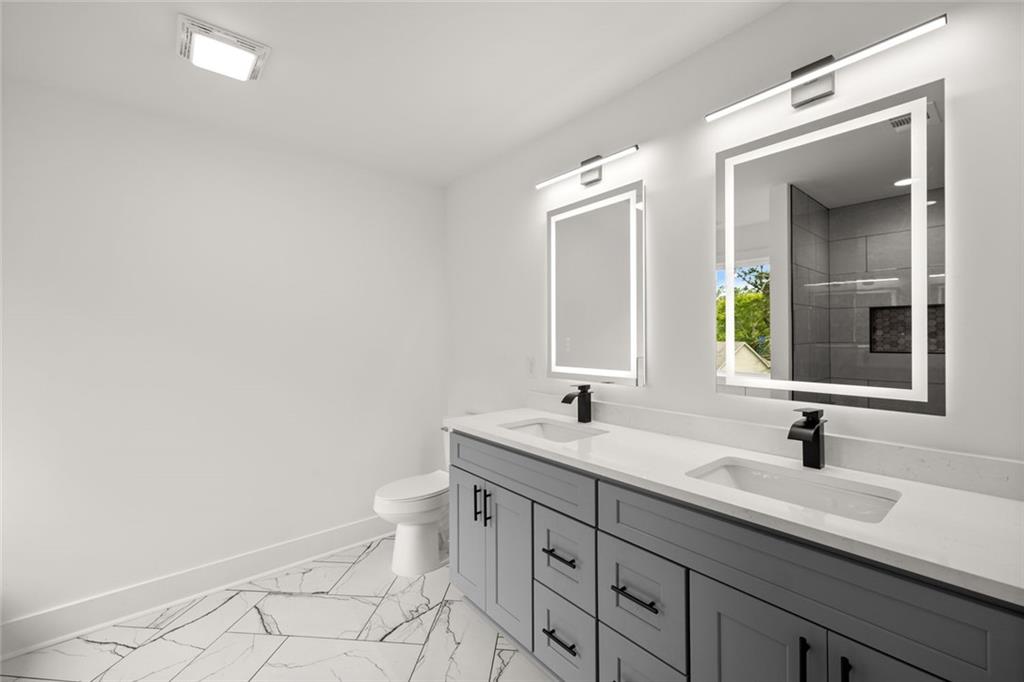 182 Hardman Road Clarkesville, GA 30523 - Photo 44 of 62 a bathroom with a double vanity sink toilet and mirror
