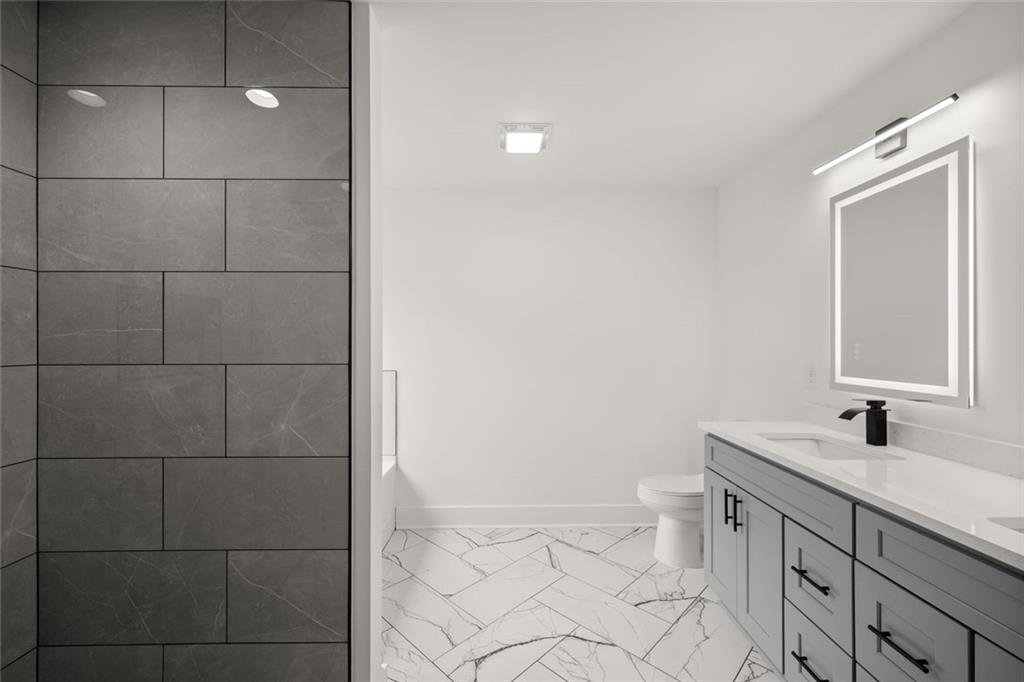 182 Hardman Road Clarkesville, GA 30523 - Photo 45 of 62 a bathroom with a double vanity sink a toilet and a mirror