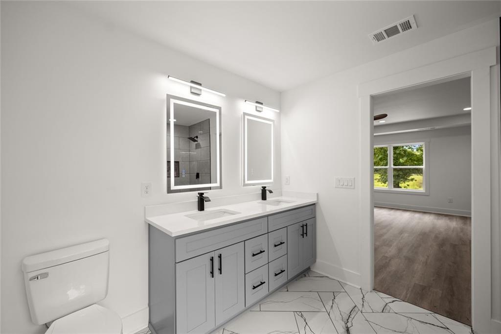 182 Hardman Road Clarkesville, GA 30523 - Photo 47 of 62 a bathroom with a toilet sink and mirror