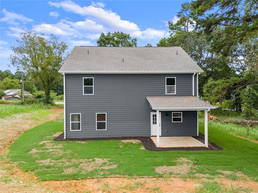 182 Hardman Road Clarkesville, GA 30523 - Photo 52 of 62 a front view of a house with a yard and garage
