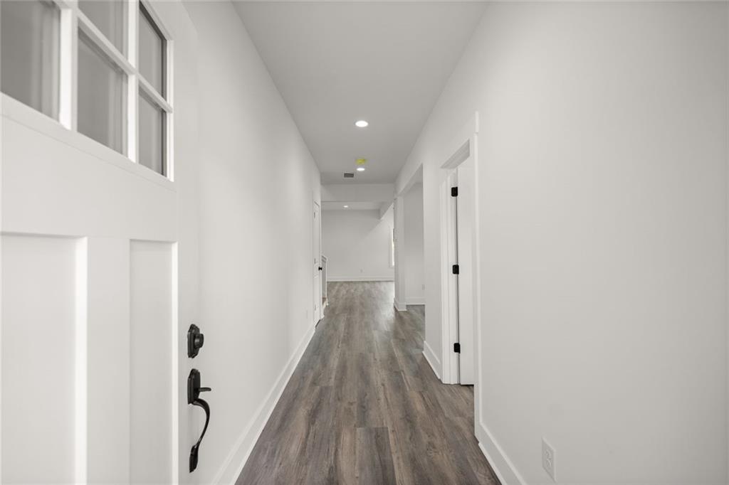 182 Hardman Road Clarkesville, GA 30523 - Photo 7 of 62 a view of a hallway with wooden floor and staircase