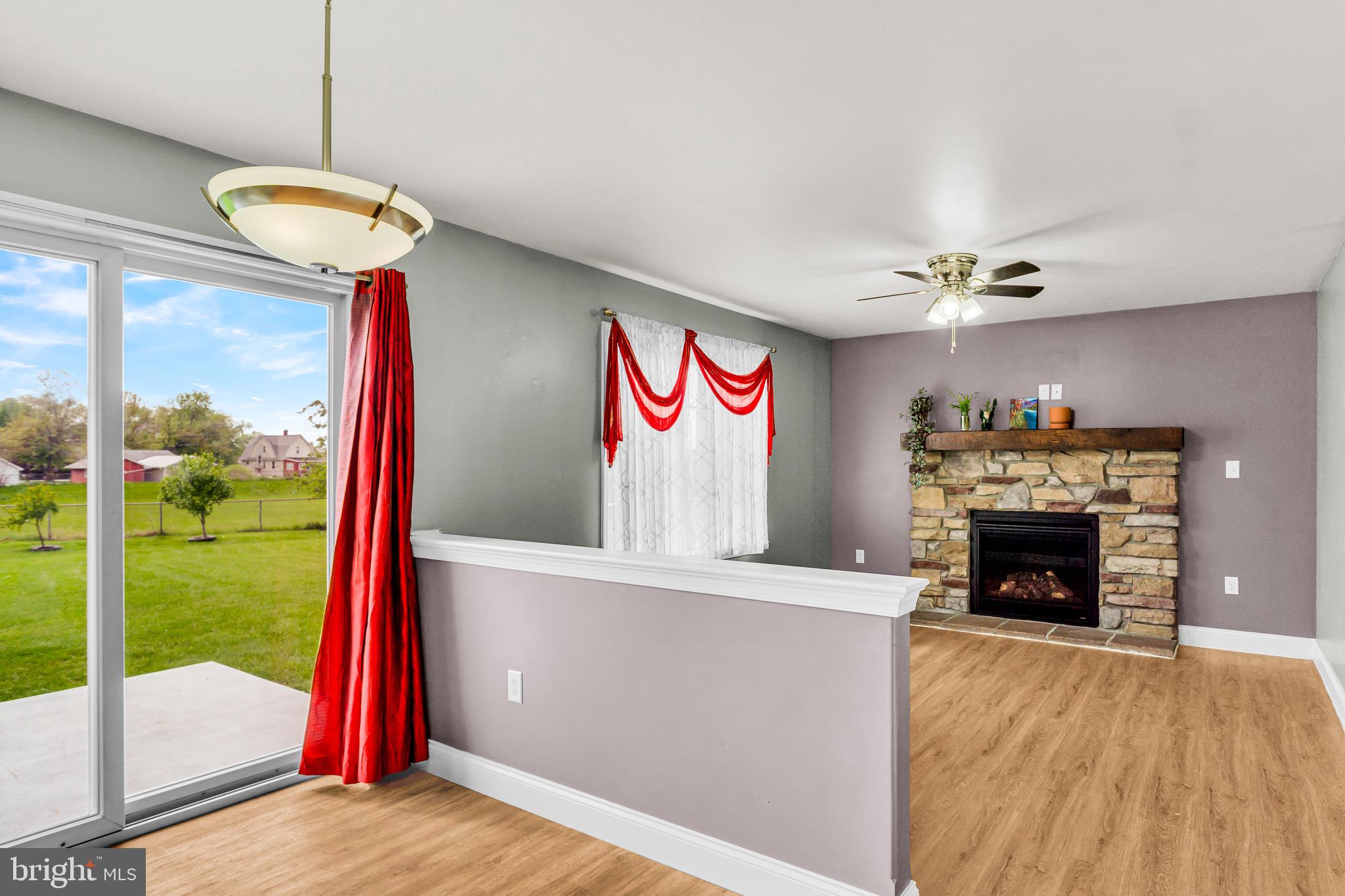 25 Springbrook Drive Palmyra, PA 17078 - Photo 14 of 34 a view of a hall with a fireplace and a floor to ceiling window