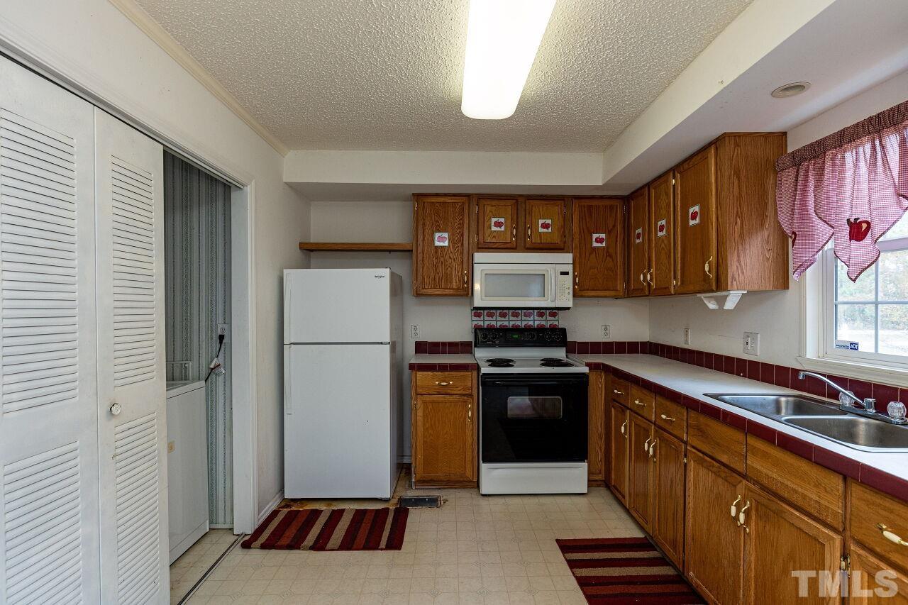 995 Genoa Road Dudley, NC 28333 - Photo 11 of 28 a kitchen with stainless steel appliances granite countertop a refrigerator sink and stove