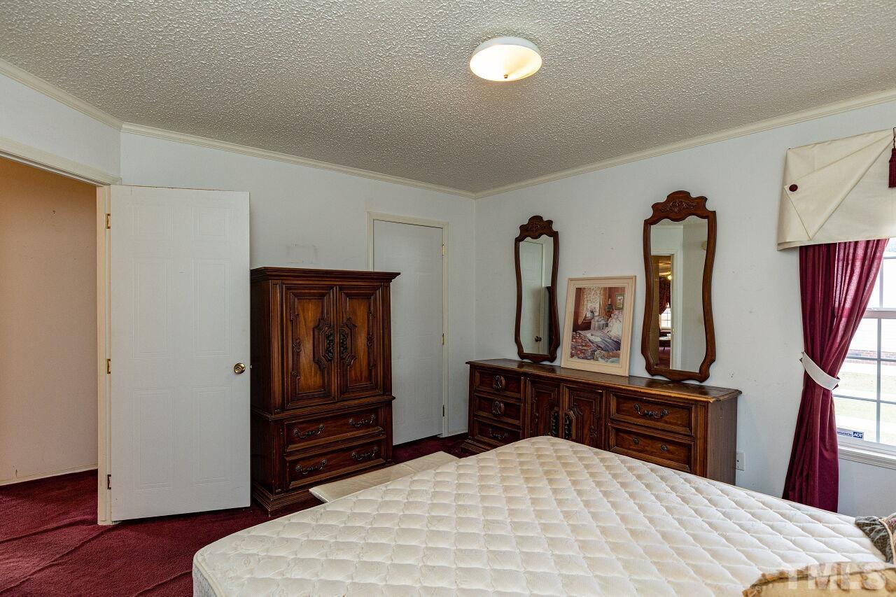 995 Genoa Road Dudley, NC 28333 - Photo 18 of 28 a bedroom with a bed and a dresser