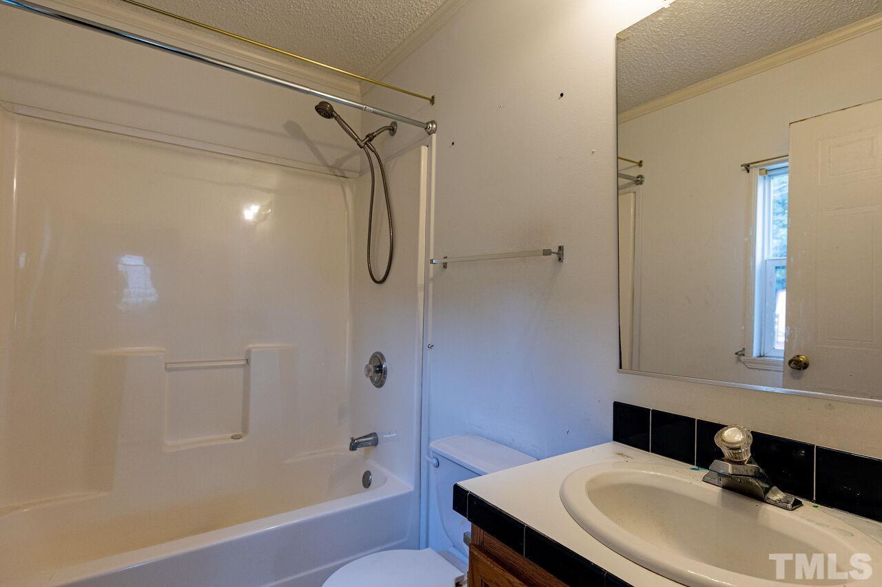 995 Genoa Road Dudley, NC 28333 - Photo 19 of 28 a bathroom with a sink toilet and shower