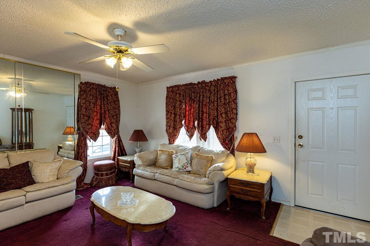 995 Genoa Road Dudley, NC 28333 - Photo 5 of 28 a living room with furniture and a chandelier