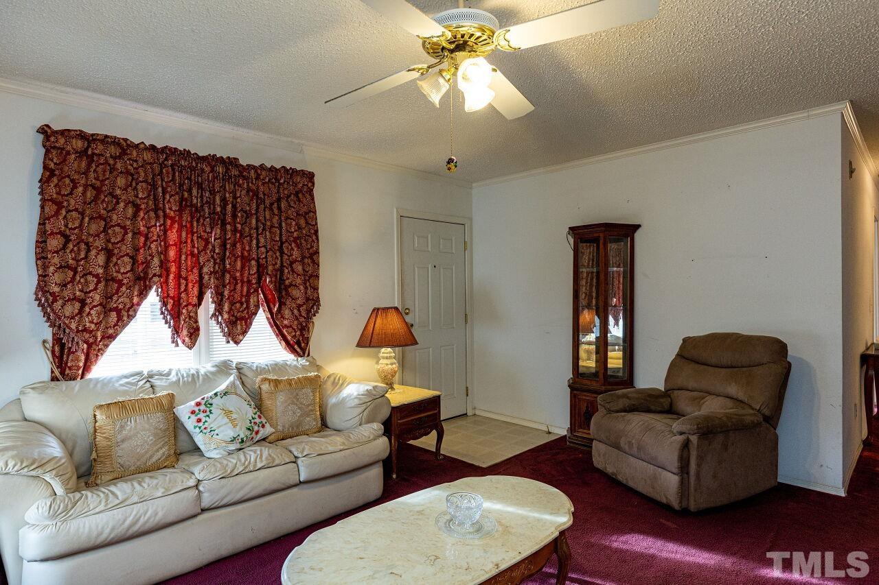 995 Genoa Road Dudley, NC 28333 - Photo 6 of 28 a living room with furniture and a chandelier