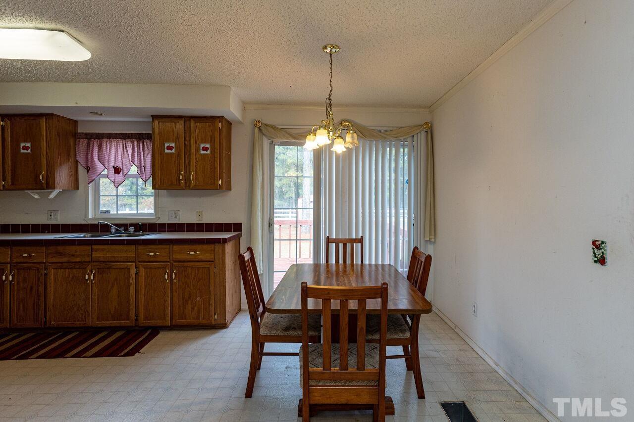 995 Genoa Road Dudley, NC 28333 - Photo 8 of 28 a kitchen with a table and chairs in it