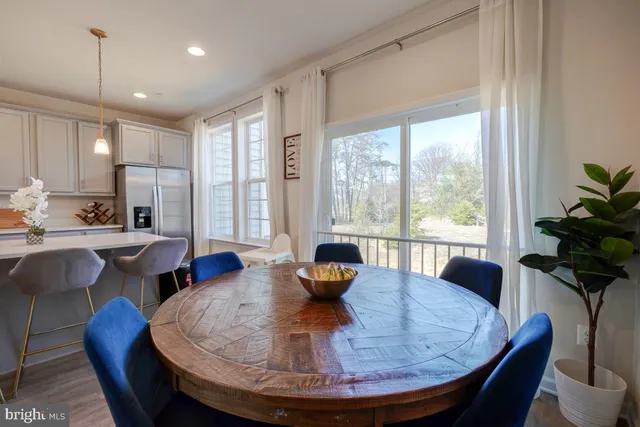 a large kitchen with a table and chairs