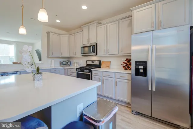 a large white kitchen with cabinets