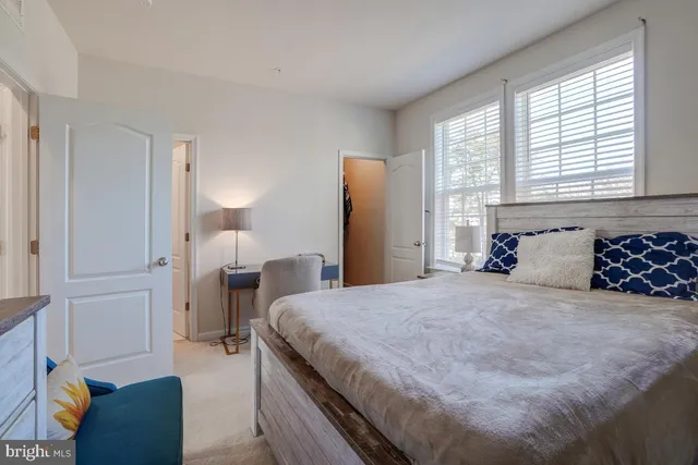 a bathroom with a granite countertop sink a toilet and a mirror