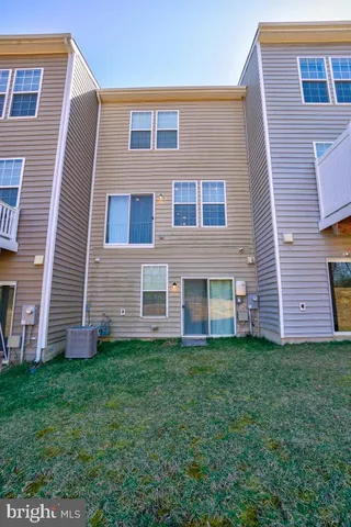 a front view of a building with lots of trees