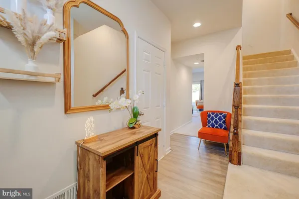 a living room with furniture a flat screen tv and a window