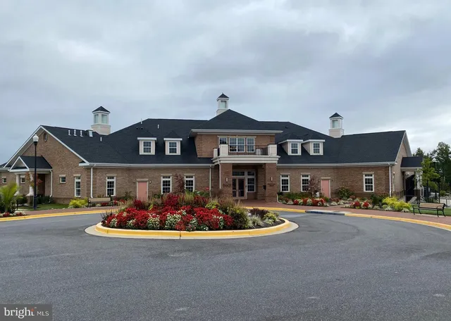 a living room with furniture a chandelier and a large window