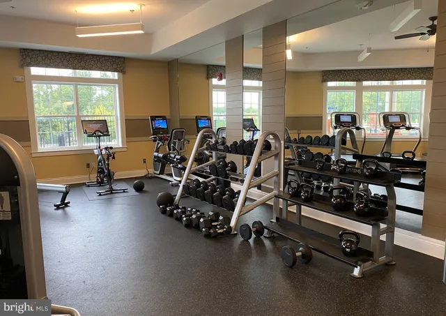 a living room with furniture pool table and a fireplace
