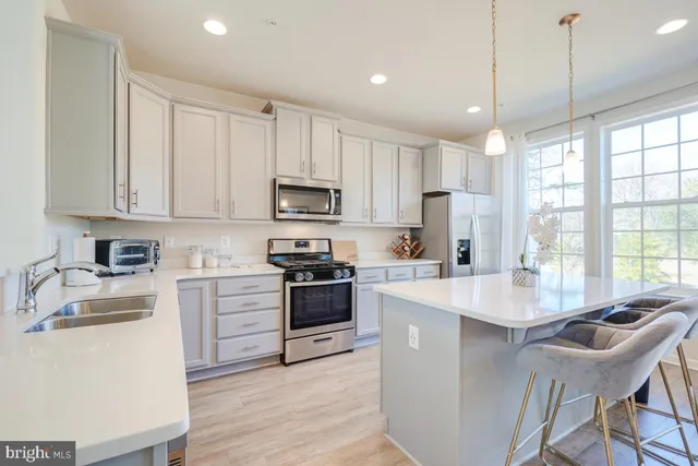 a dining room with furniture a large window and wooden floor