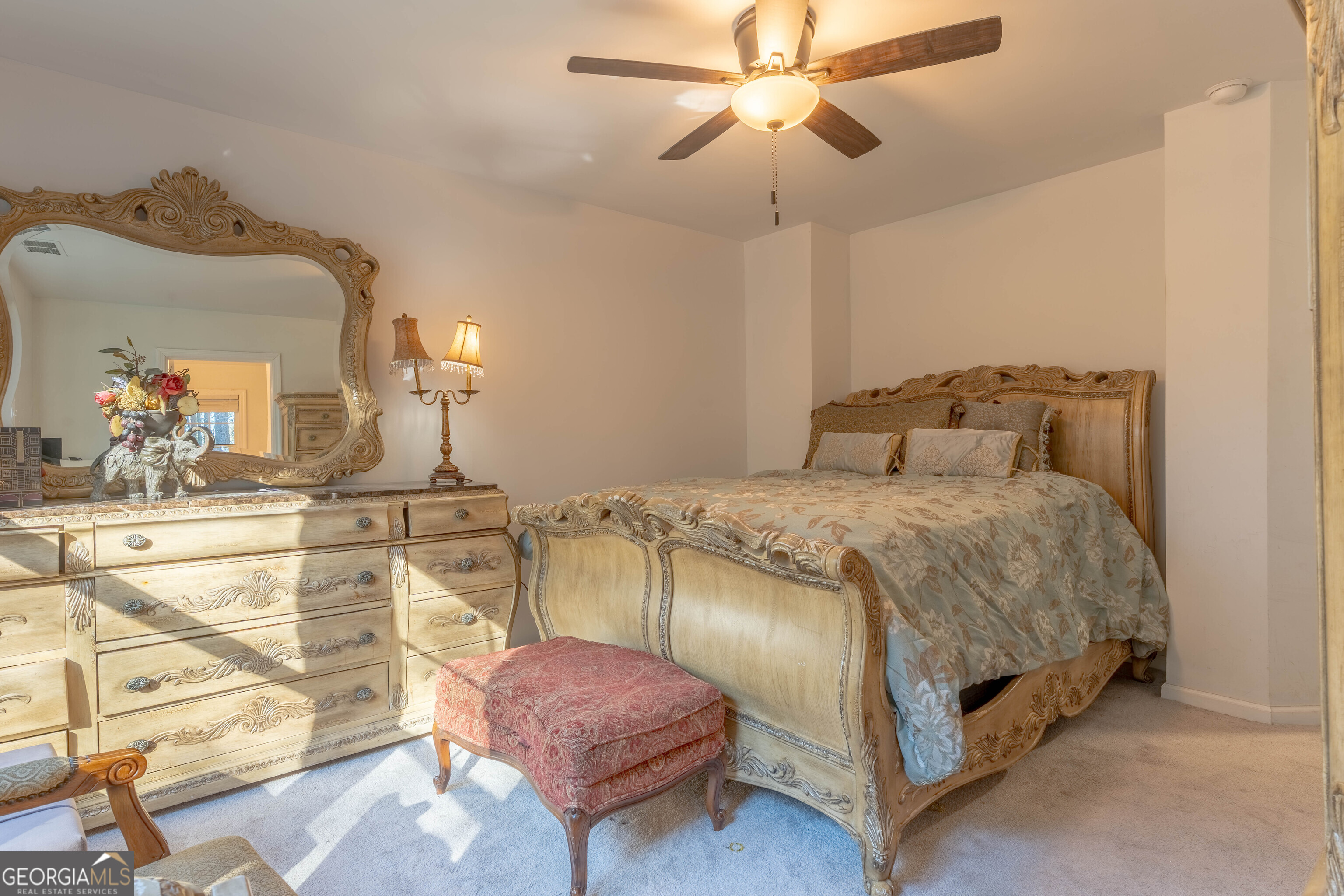 157 Watkins Road Flovilla, GA 30216 - Photo 15 of 31 a bedroom with a bed and a chandelier