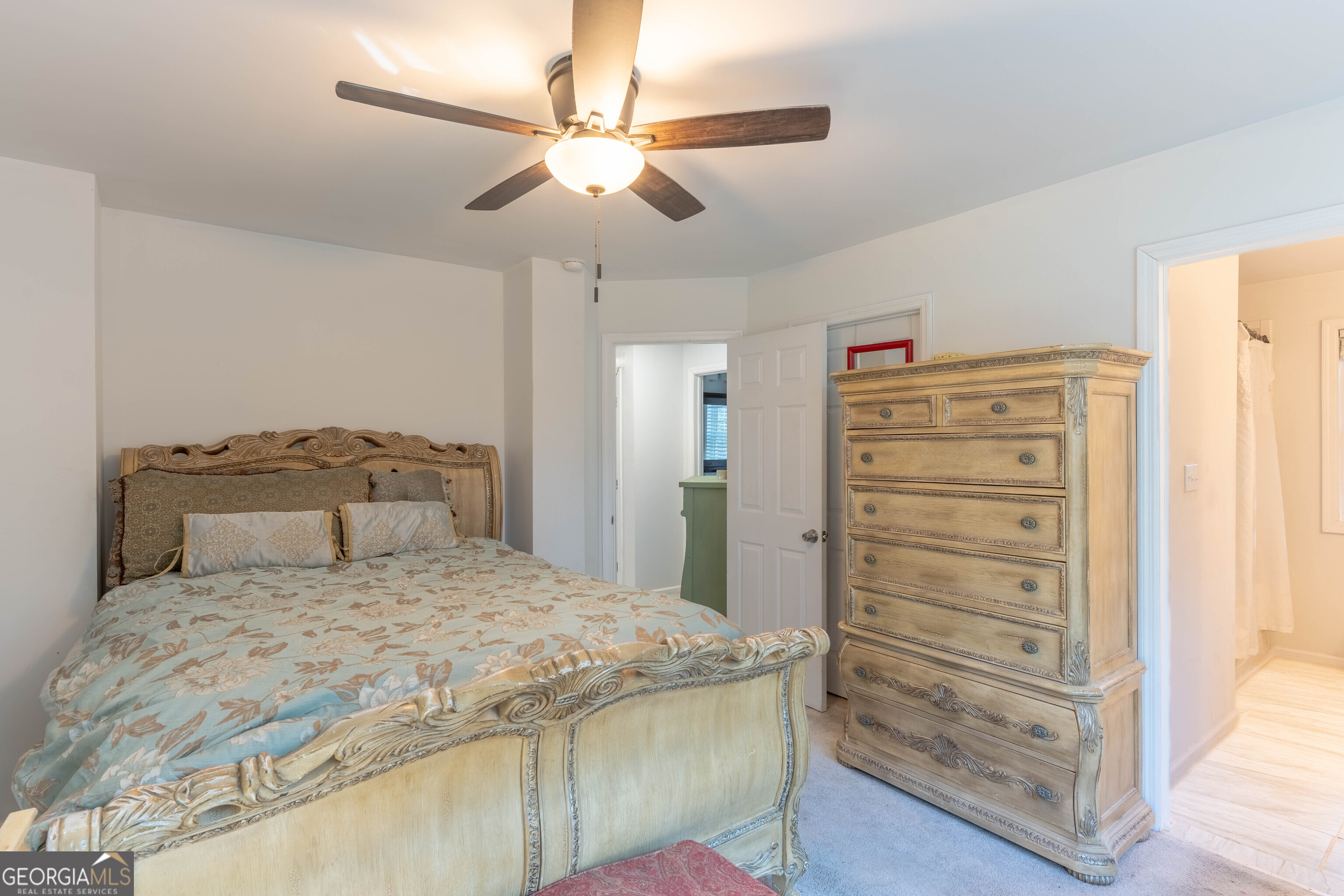 157 Watkins Road Flovilla, GA 30216 - Photo 17 of 31 a bedroom with a bed and a chandelier