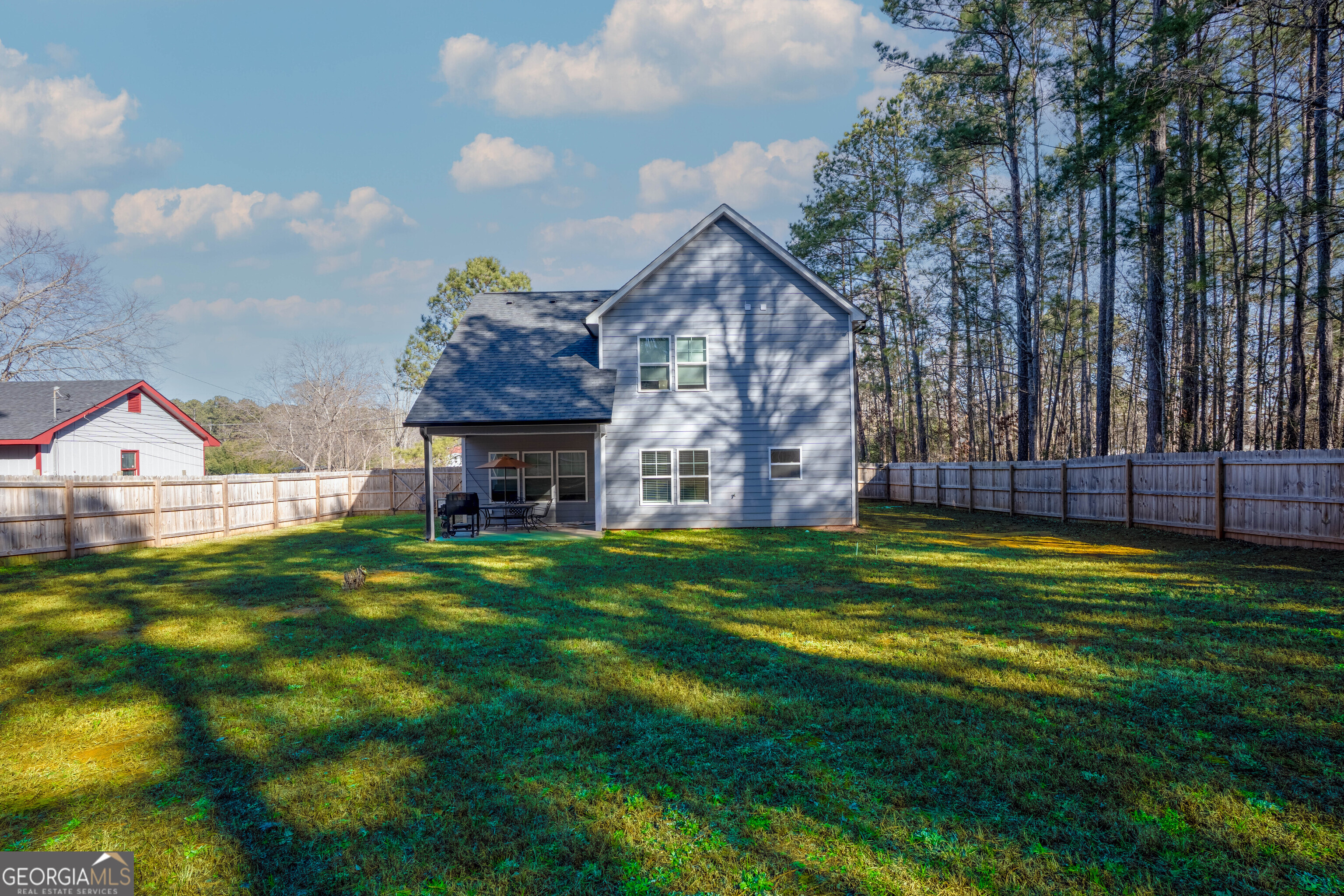 157 Watkins Road Flovilla, GA 30216 - Photo 30 of 31 a view of a house with a big yard and large trees
