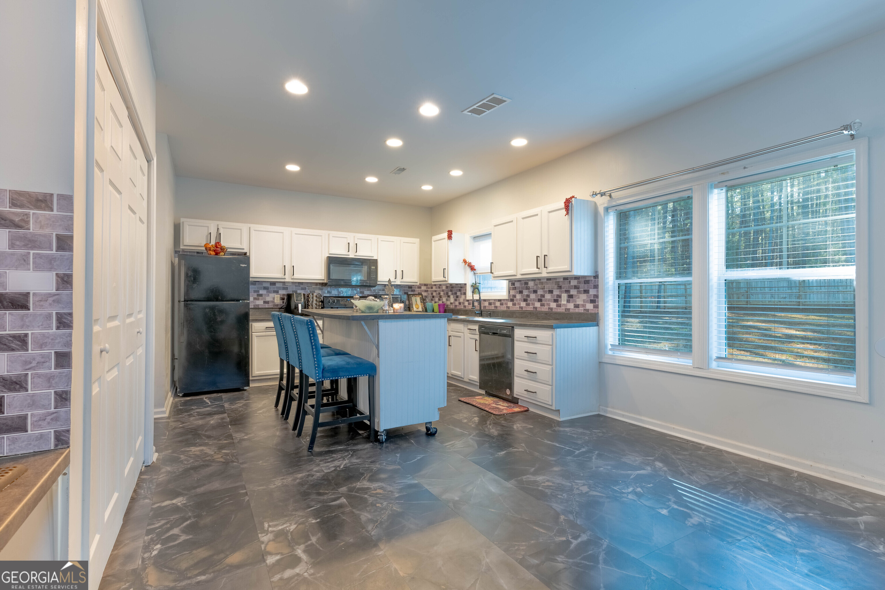 157 Watkins Road Flovilla, GA 30216 - Photo 7 of 31 a kitchen with a refrigerator and a table