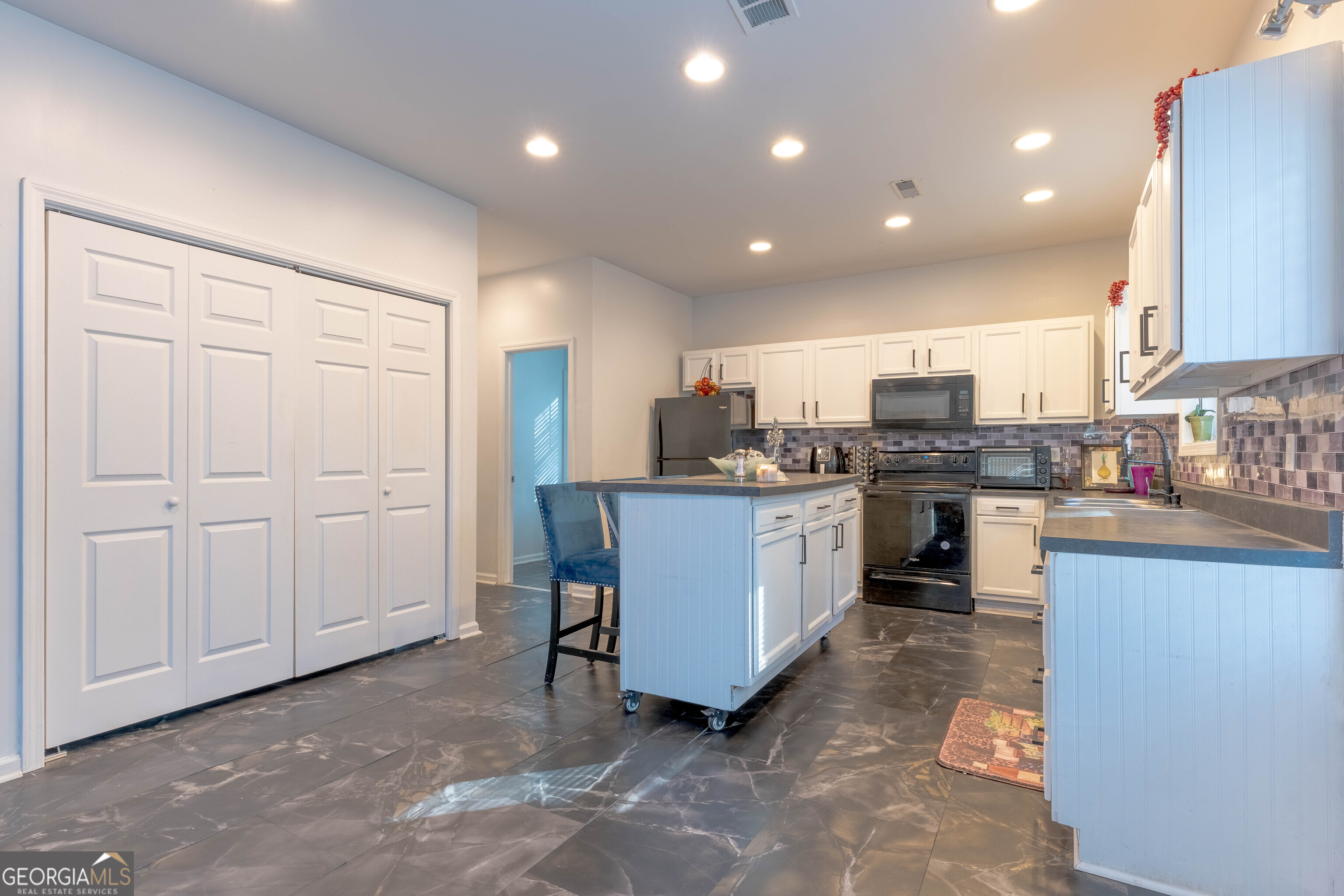 157 Watkins Road Flovilla, GA 30216 - Photo 8 of 31 a kitchen with refrigerator cabinets and microwave