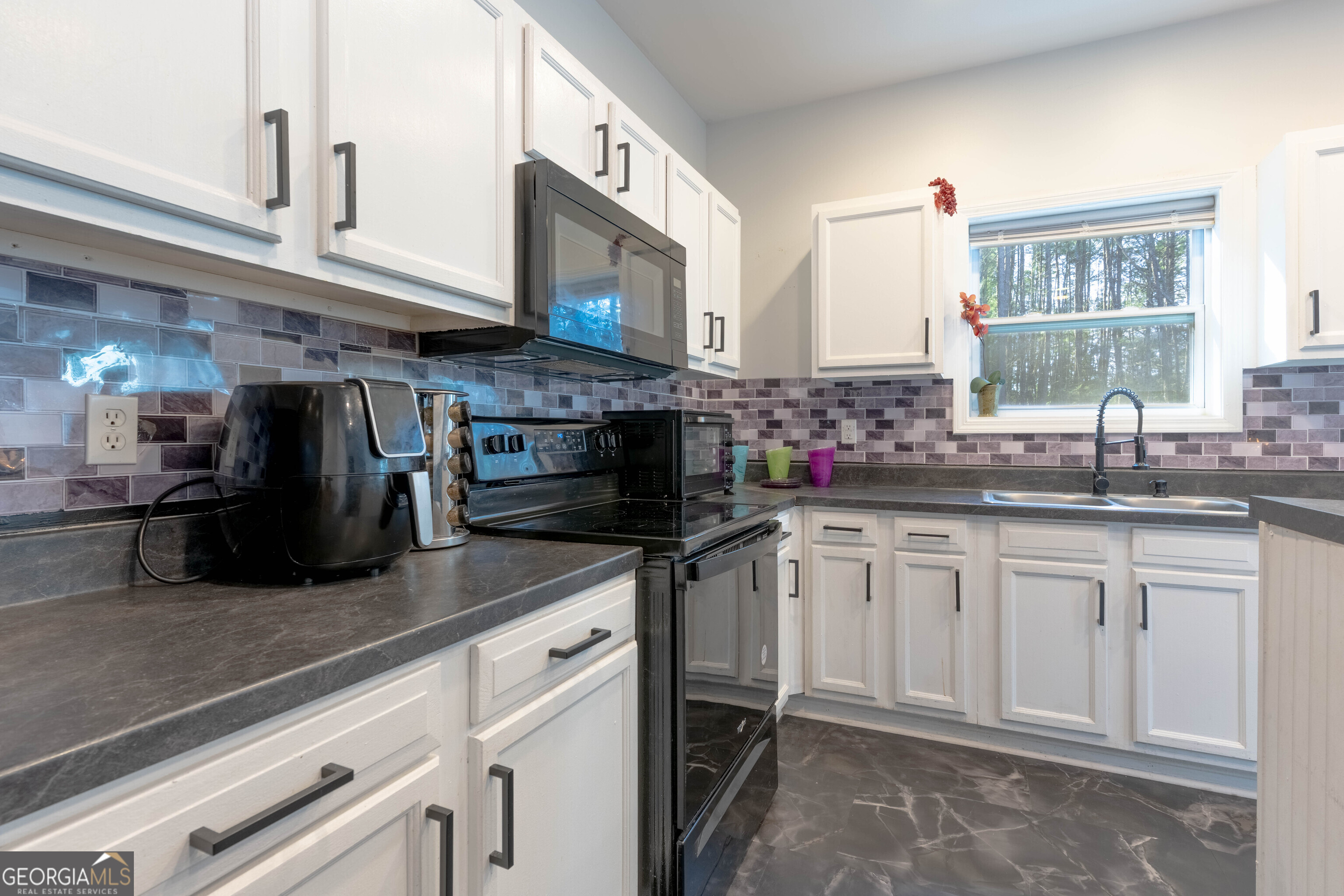 157 Watkins Road Flovilla, GA 30216 - Photo 9 of 31 a kitchen with stainless steel appliances granite countertop a sink and a stove