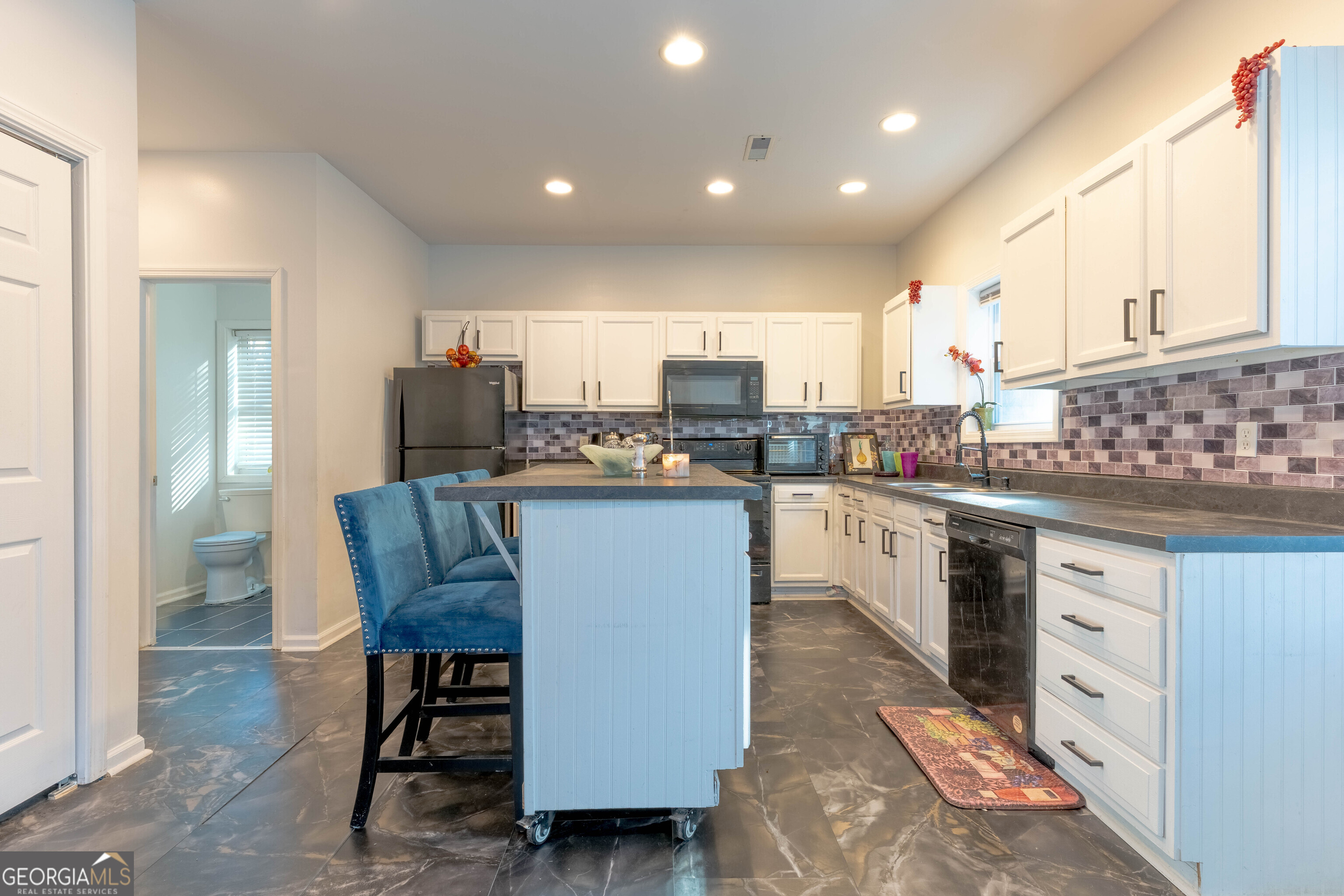 157 Watkins Road Flovilla, GA 30216 - Photo 10 of 31 a kitchen with stainless steel appliances granite countertop a stove top oven a sink dishwasher and cabinets with wooden floor