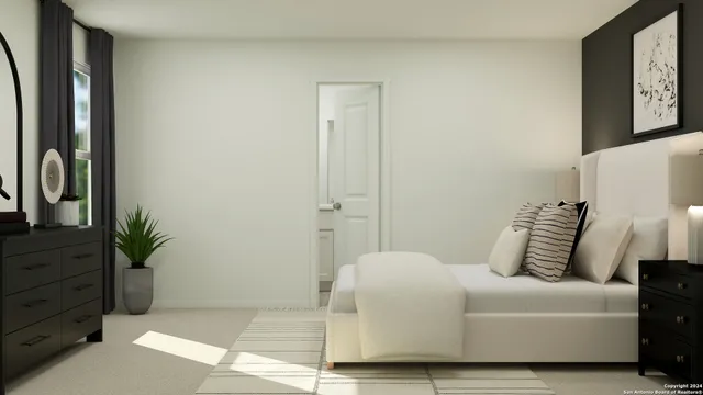 a bedroom with a bed and a potted plant