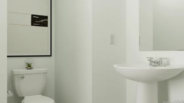 a bathroom with a sink a toilet and mirror