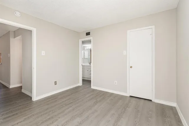 an empty room with wooden floor