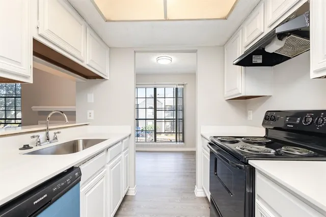 a kitchen with stainless steel appliances granite countertop a sink stove and cabinets