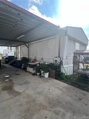 a view of parking with a table and chairs and potted plants