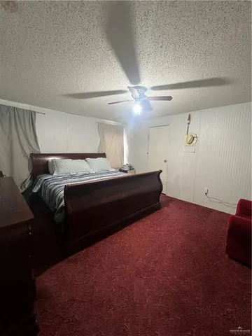 a bedroom with a bed and a night stand