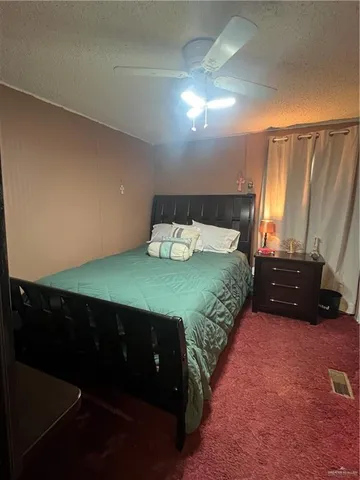 a bedroom with a bed and a night stand