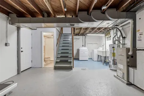 a view of water heater room with stairs