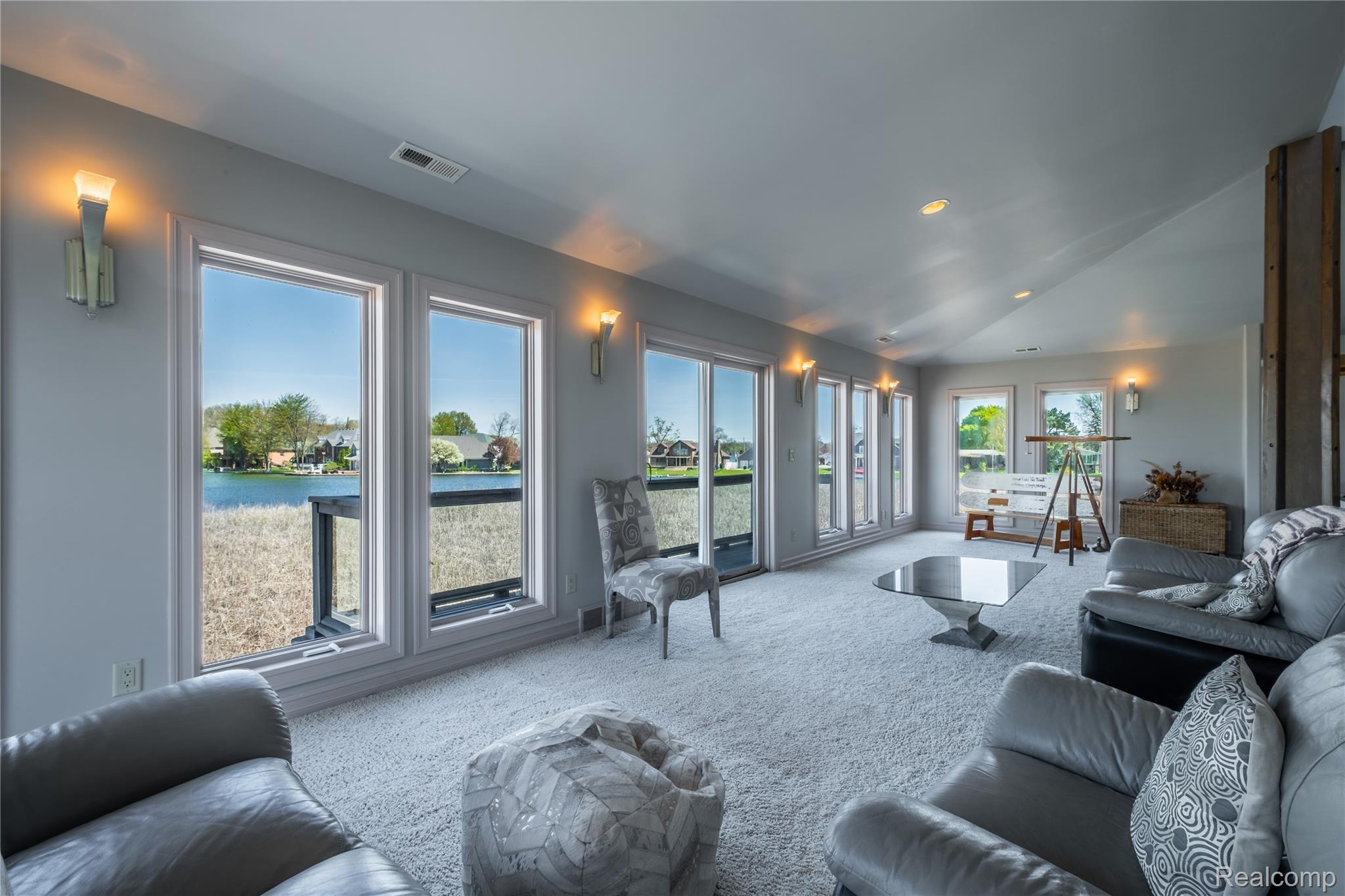 2350 Crane Road Fenton, MI 48430 - Photo 21 of 58 Living area featuring carpet flooring, vaulted ceiling, a water view, and recessed lighting