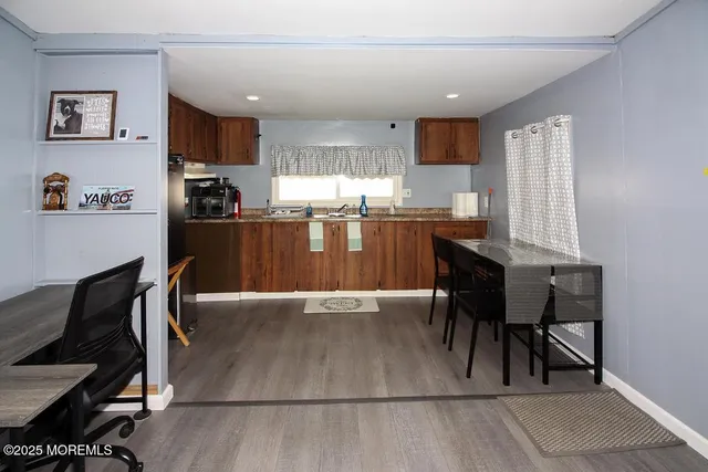 a kitchen with granite countertop a sink appliances and cabinets